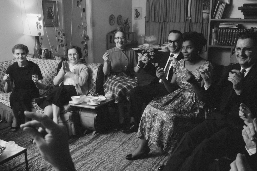 Group of editorial journalists reviewing television archive footage together